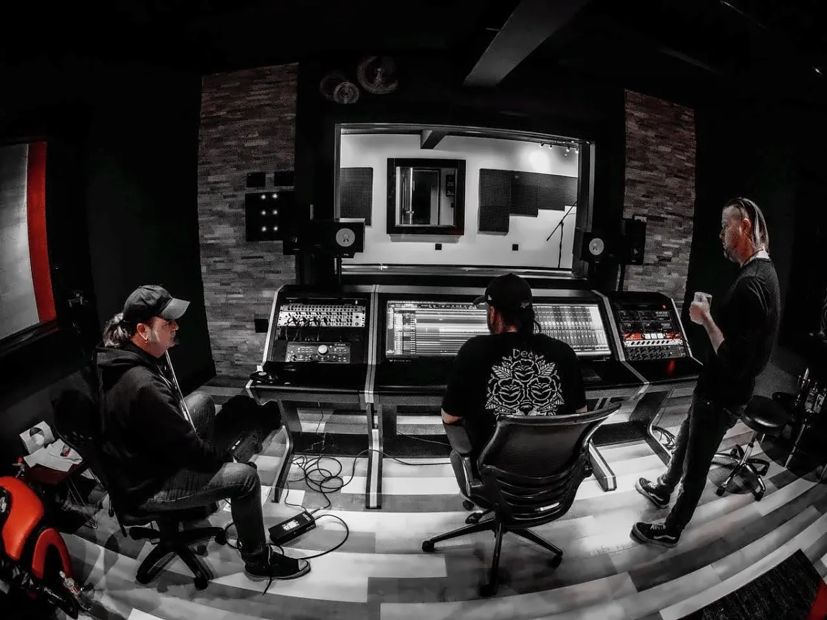 Black-and-white view of the control room with the band Flaw