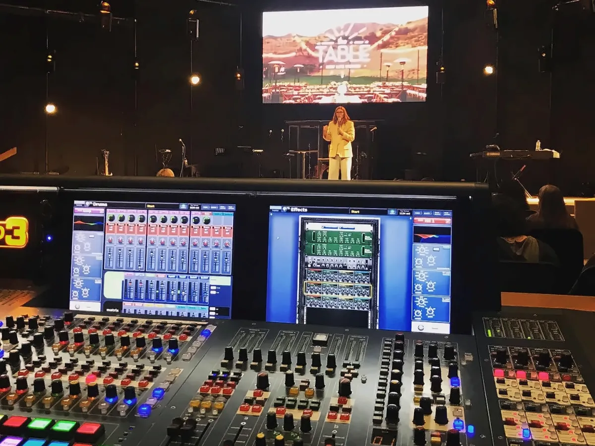 Midas Pro console at front of house, stage and screen beyond, at New Life Church