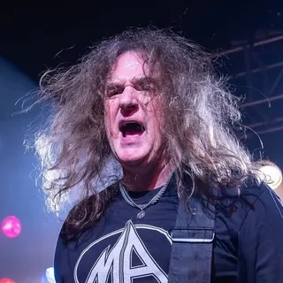 David Ellefson performing on stage with a bass